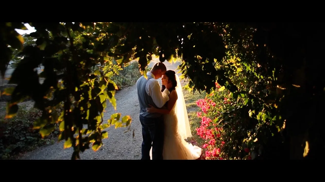 Wedding couple embracing in a garden at golden hour